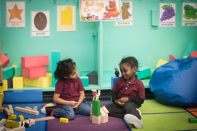 Two students sitting on the floor of a 3-k classroom at PS/IS 323 in Brooklyn in 2018.